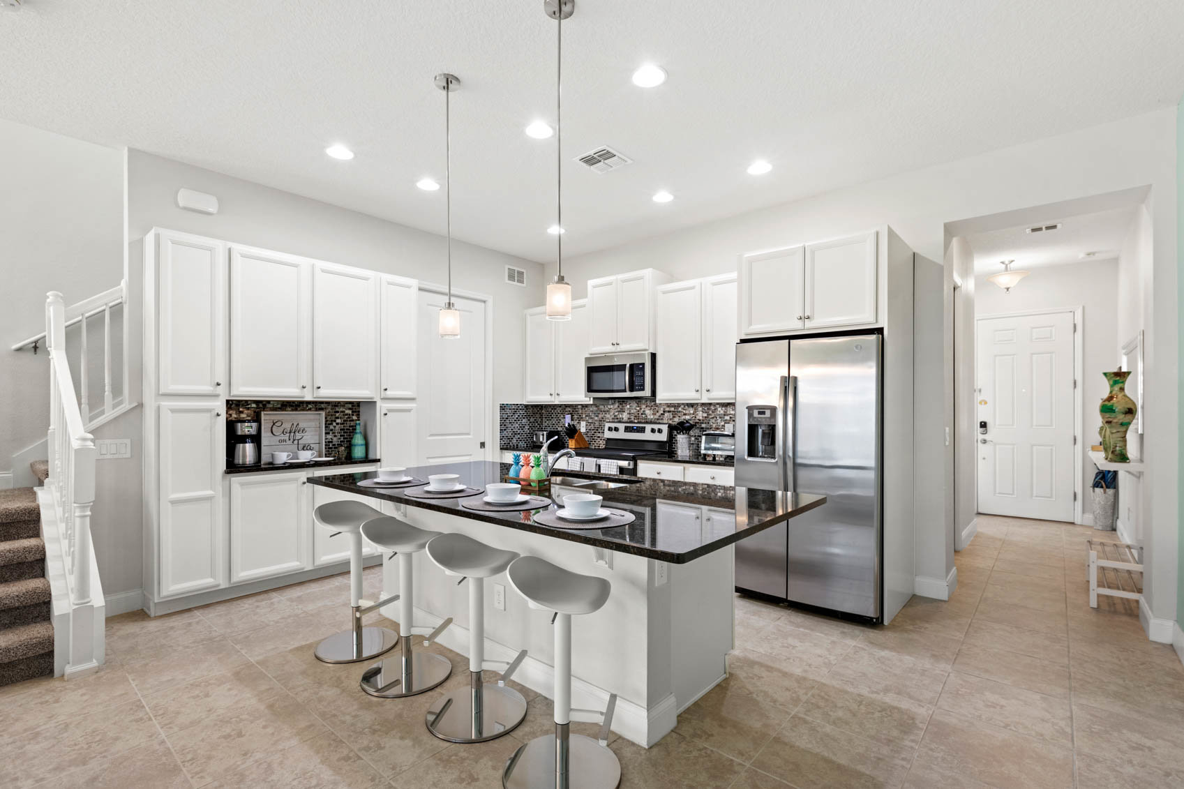 kitchen with dark counter and white cabinets
